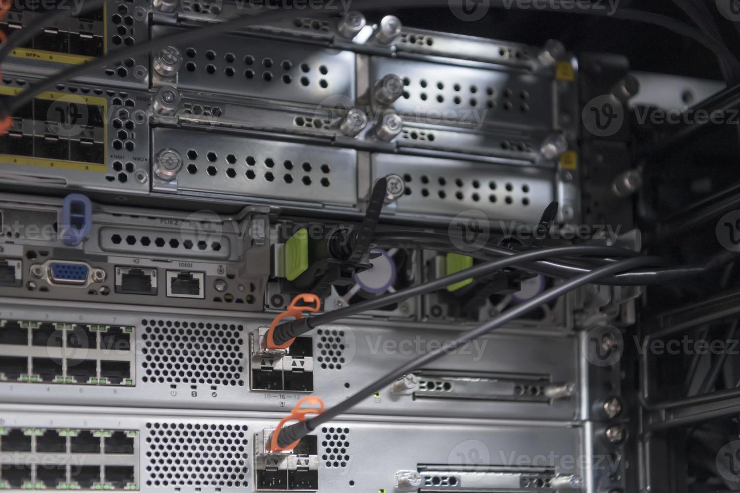 network server room closeup on fiber optic hub or switch for digital communications and internet in mainframe corporate business data center supercomputer. photo