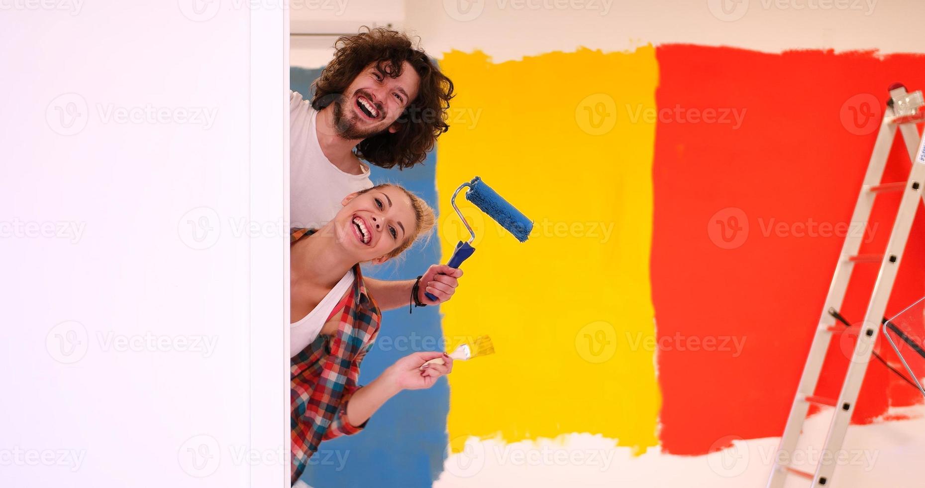 portrait of a couple painting interior wall photo