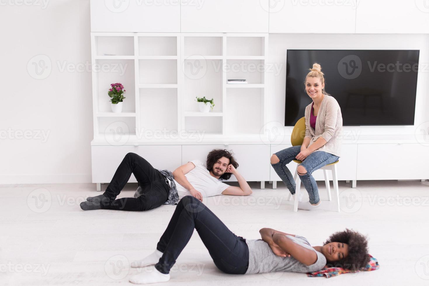multiethnic group of people relax in their new apartment photo