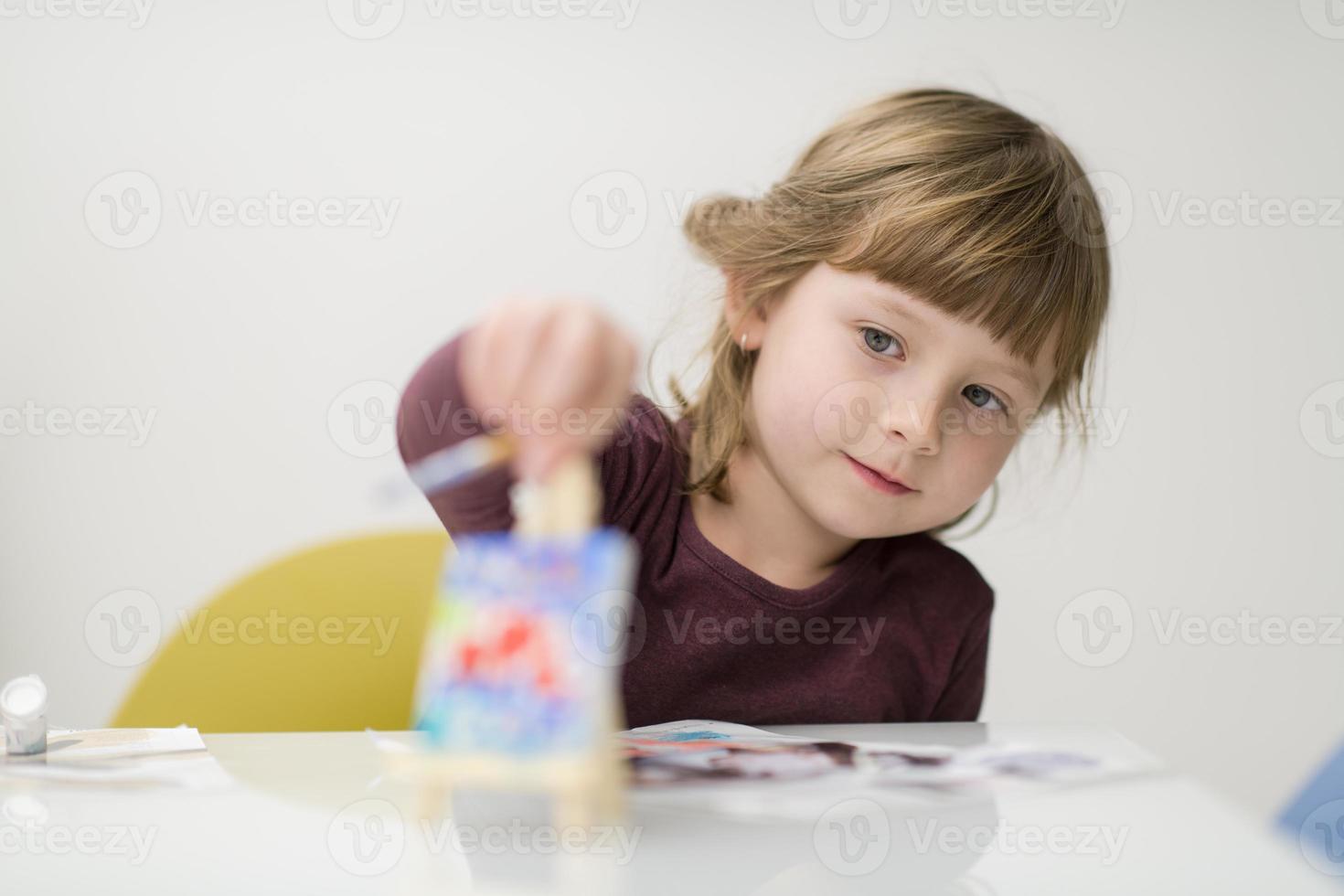 little girl painting on canvas photo