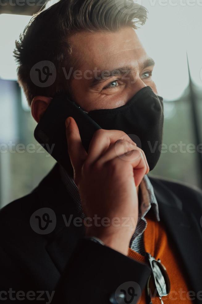 business man wearing protective face mask at office photo