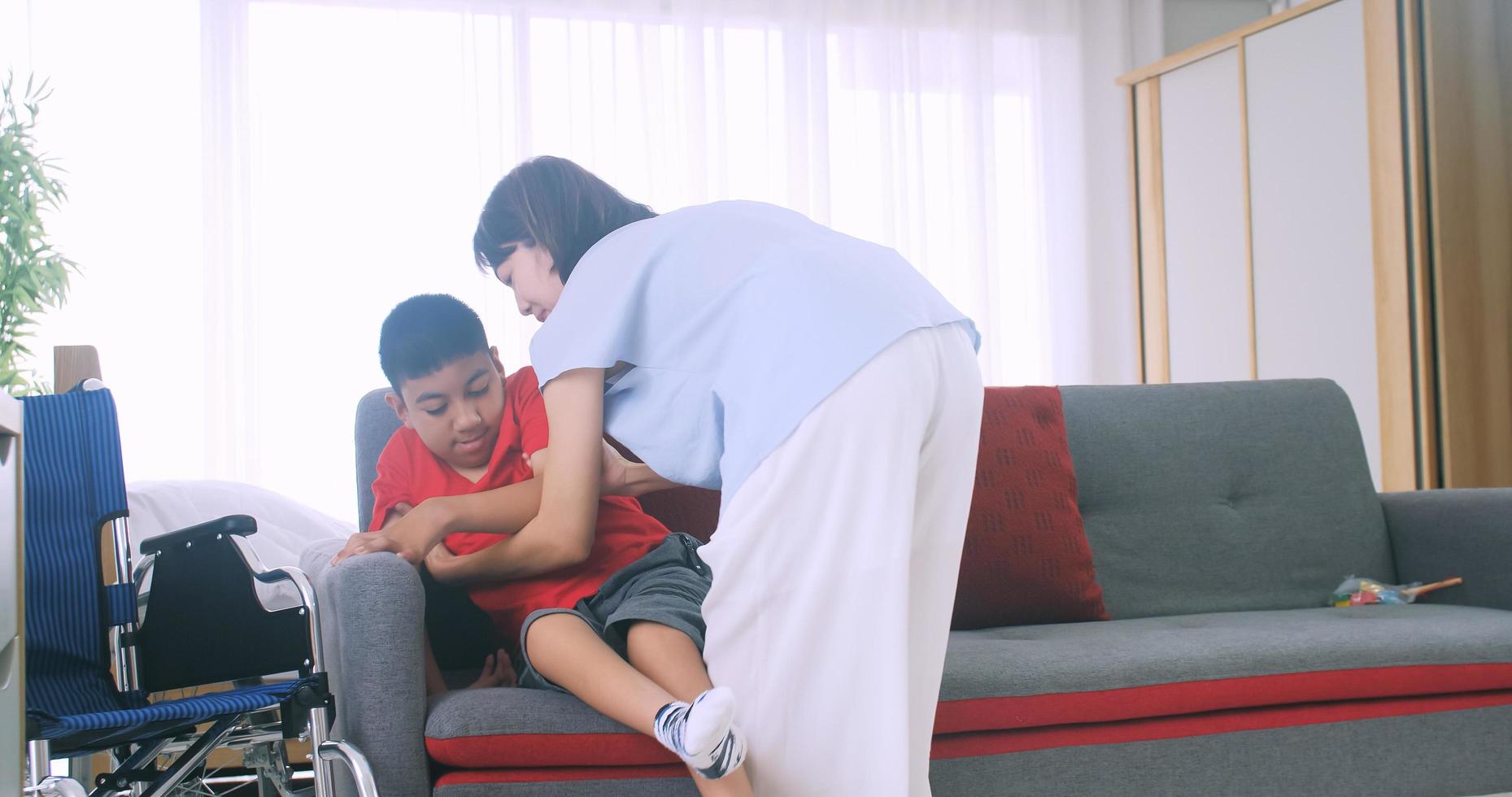 Happy family with mother and disabled son spending time together at home. photo