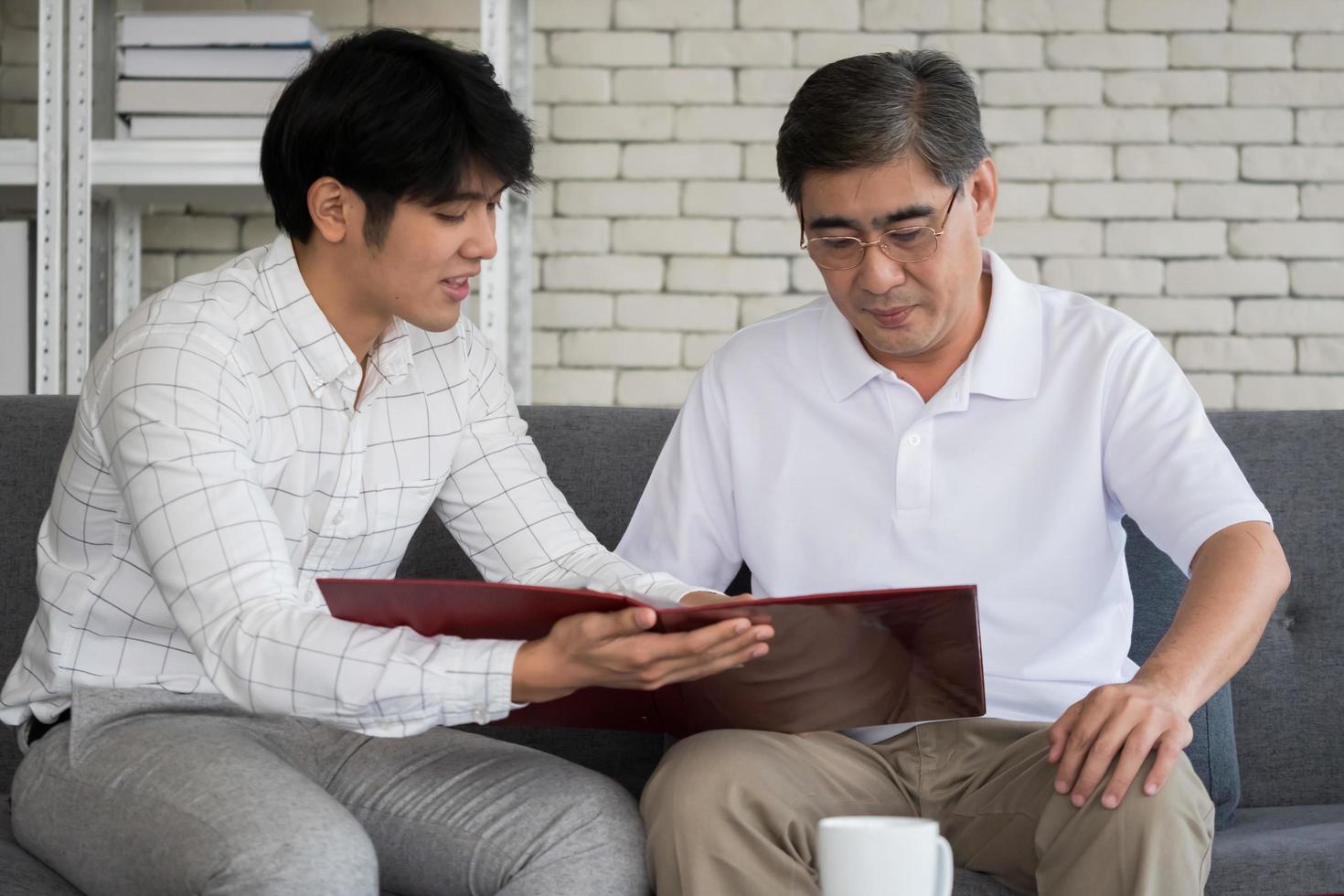 Young man agent recommending life insurance to senior man. photo