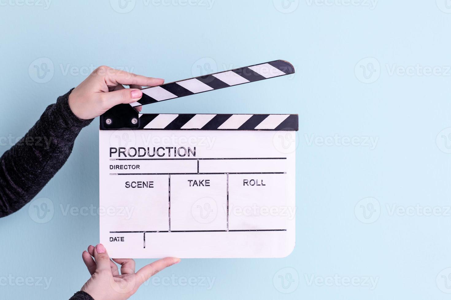 movie clapper isolated on cyan background photo