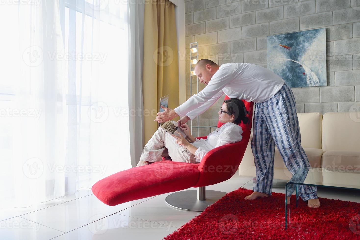 young couple using Laptop computer at home photo