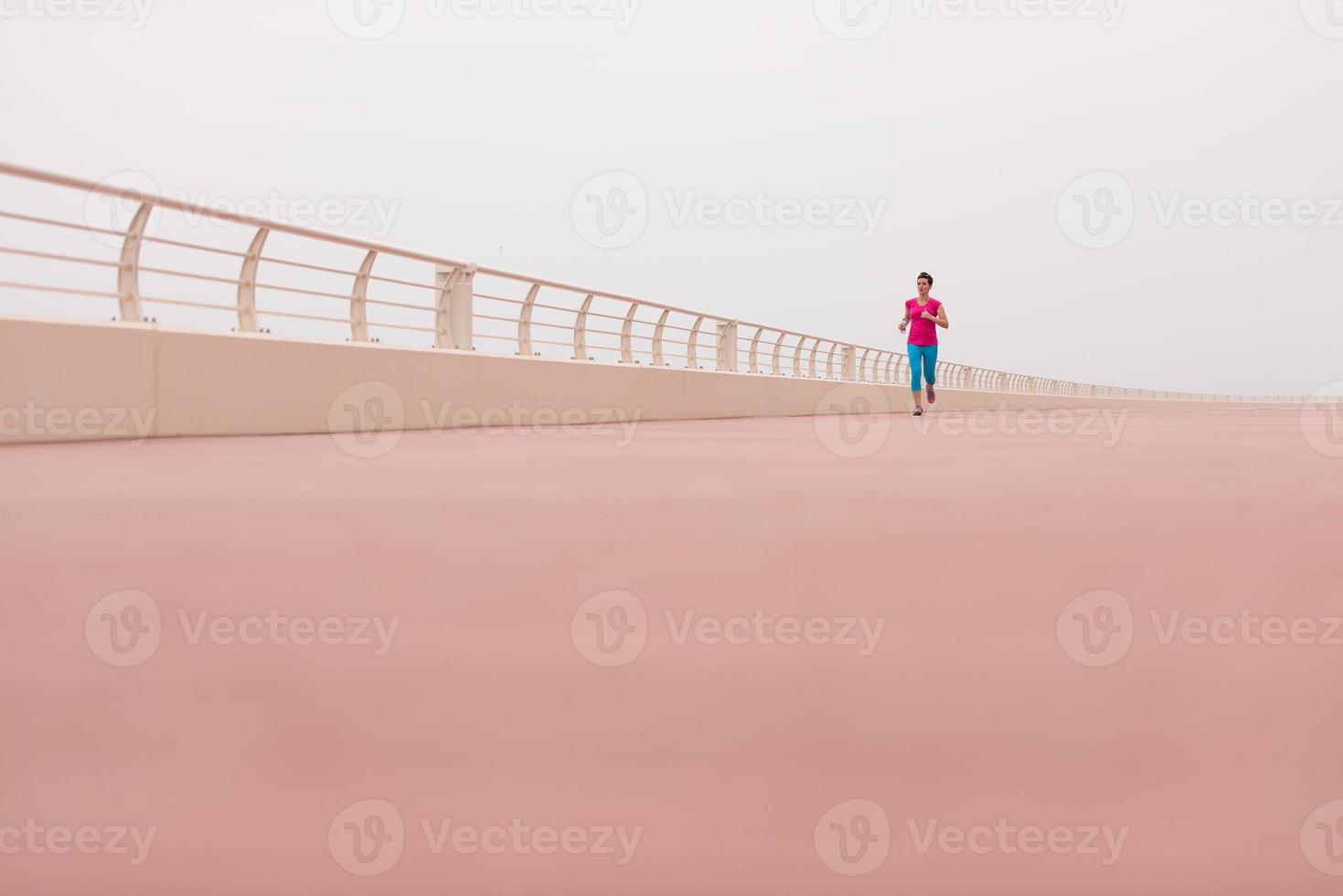 woman busy running on the promenade photo