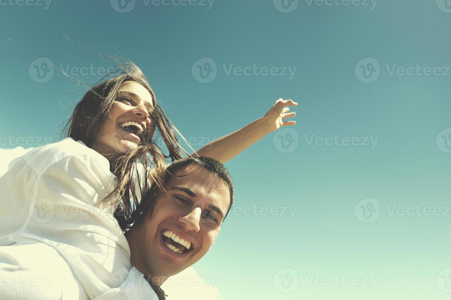 happy young couple have fun on beach photo