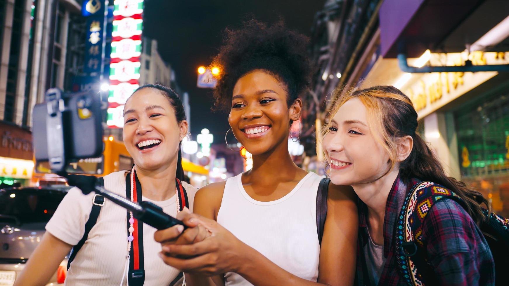 Groups of multi-ethnic female friends are enjoying a night out on Yaowarat Road or Chinatown in Bangkok, Thailand. photo