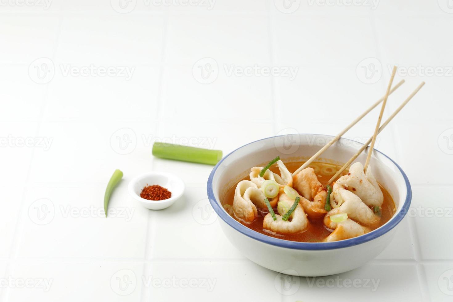 Eomukguk or Odeng Soup, Korean Popular Street Food Made from Fish Cake Eomuk and Spicy Gochujang Paste. On White Table photo