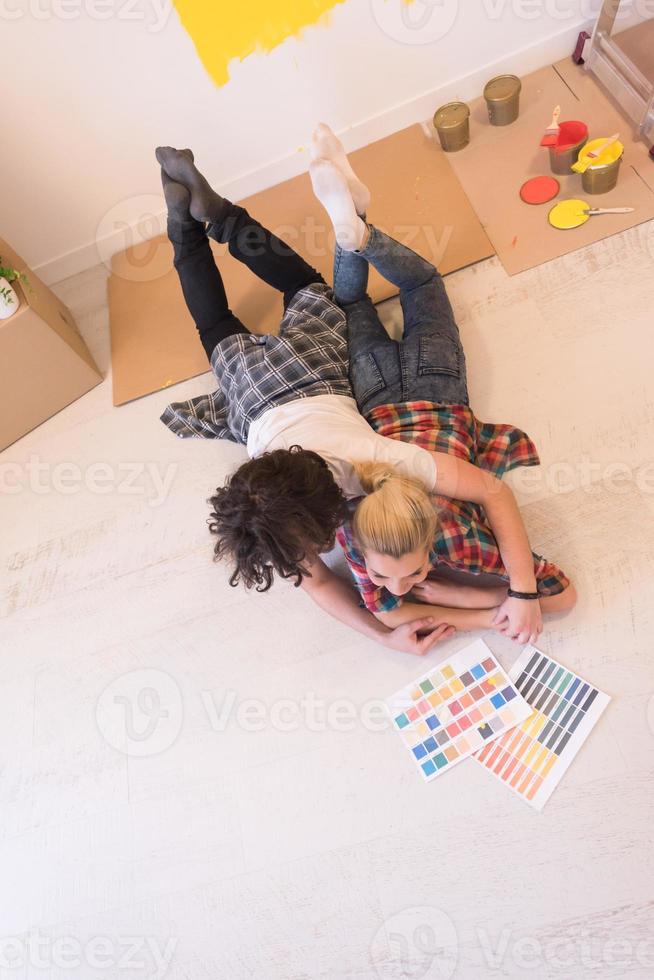 Happy young couple relaxing after painting photo