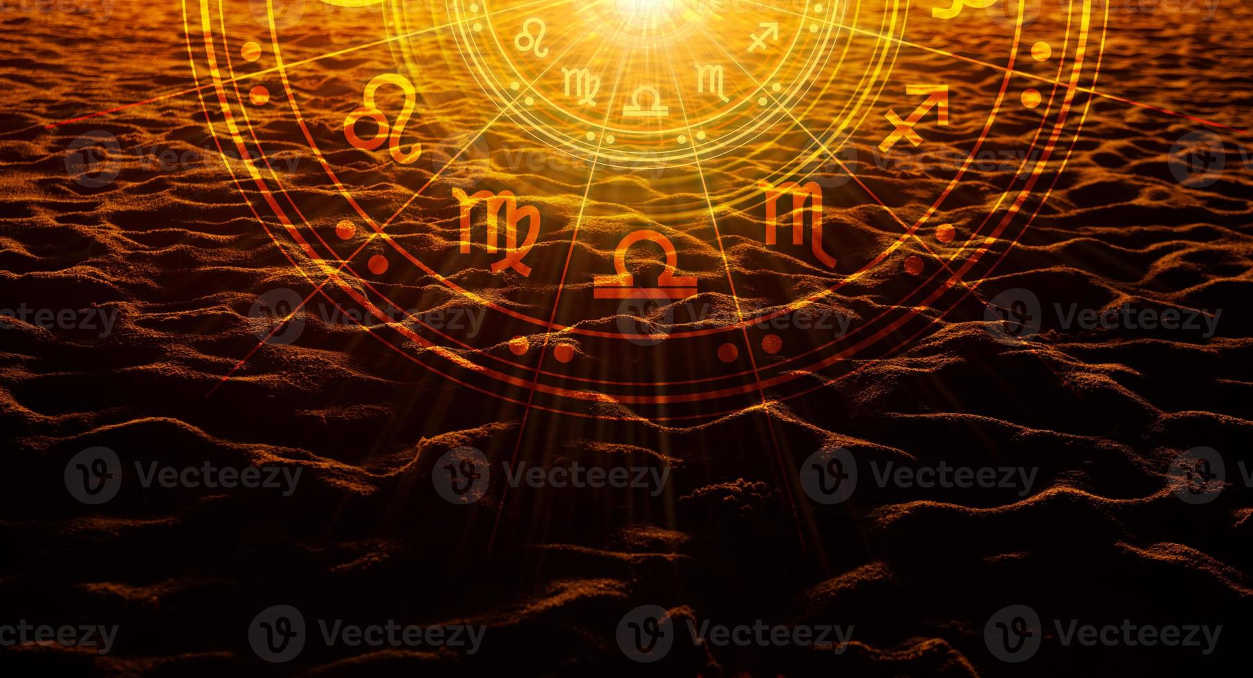 Sand of a beach in the sunset with the sun light passing through have astrological symbols. photo