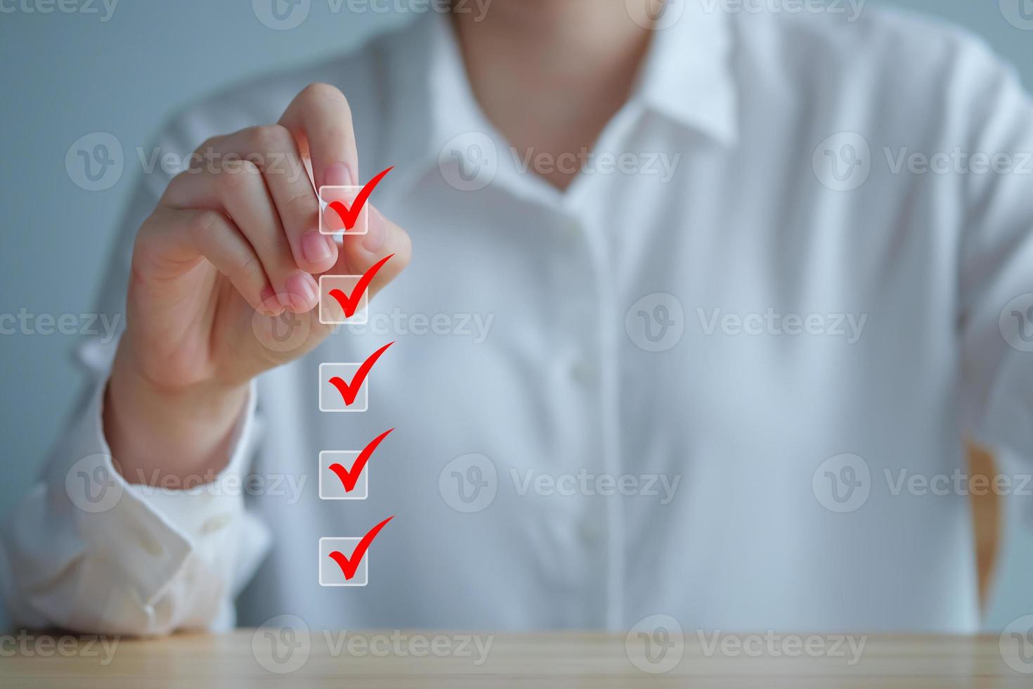 Checklist, Task list, Survey and assessment. Quality Control. Goals achievement and business success. Hand write check mark on check box for complete check list. photo