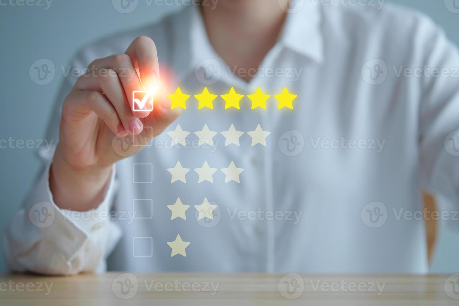 Customer Experience Concept. Review, increase rating or ranking, evaluation, feedback and classification concept. Businesswoman tick checkmark on checkbox for five yellow stars to rating review. photo