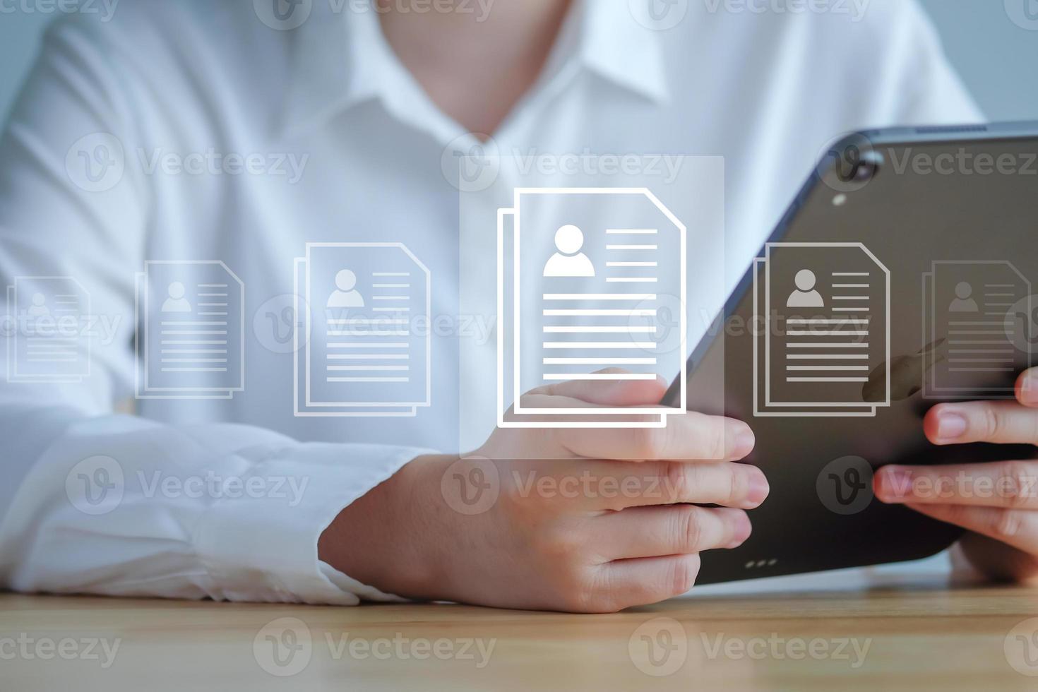 Human resource manager using tablet for check resume or CV online to choose new employee for organization. Business hiring, headhunter, recruitment, Technology for simplifying the human resource. photo