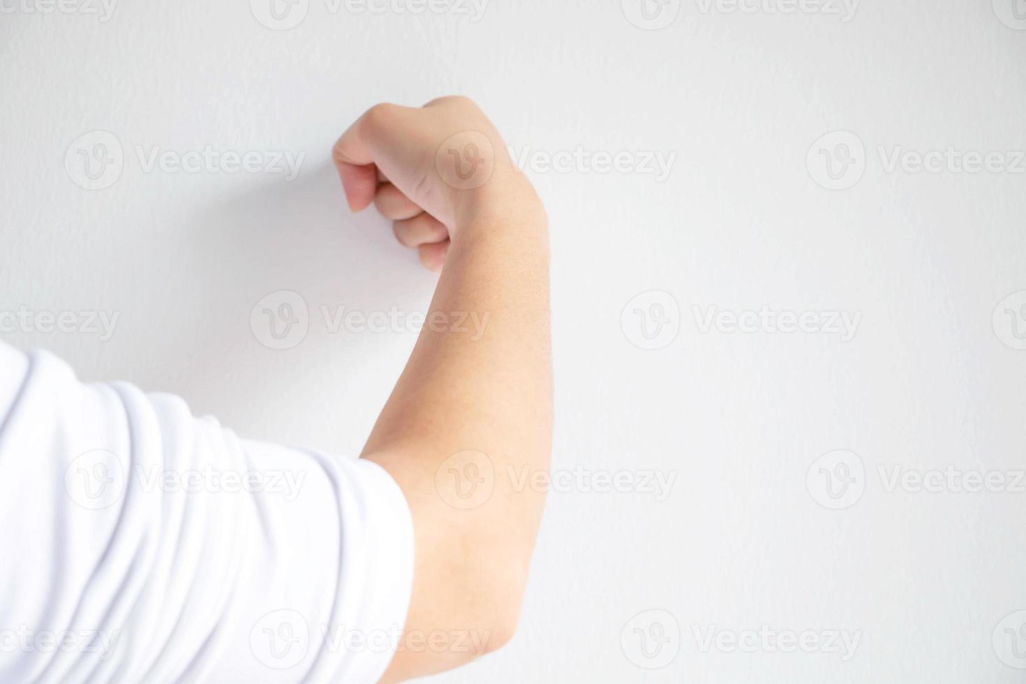 woman use her fist pounding the wall. photo