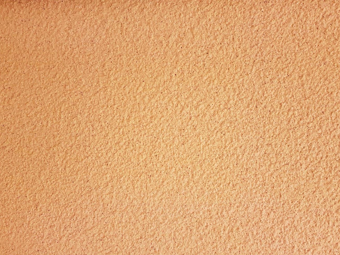 pared de guijarros de color naranja pastel en primer plano. foto