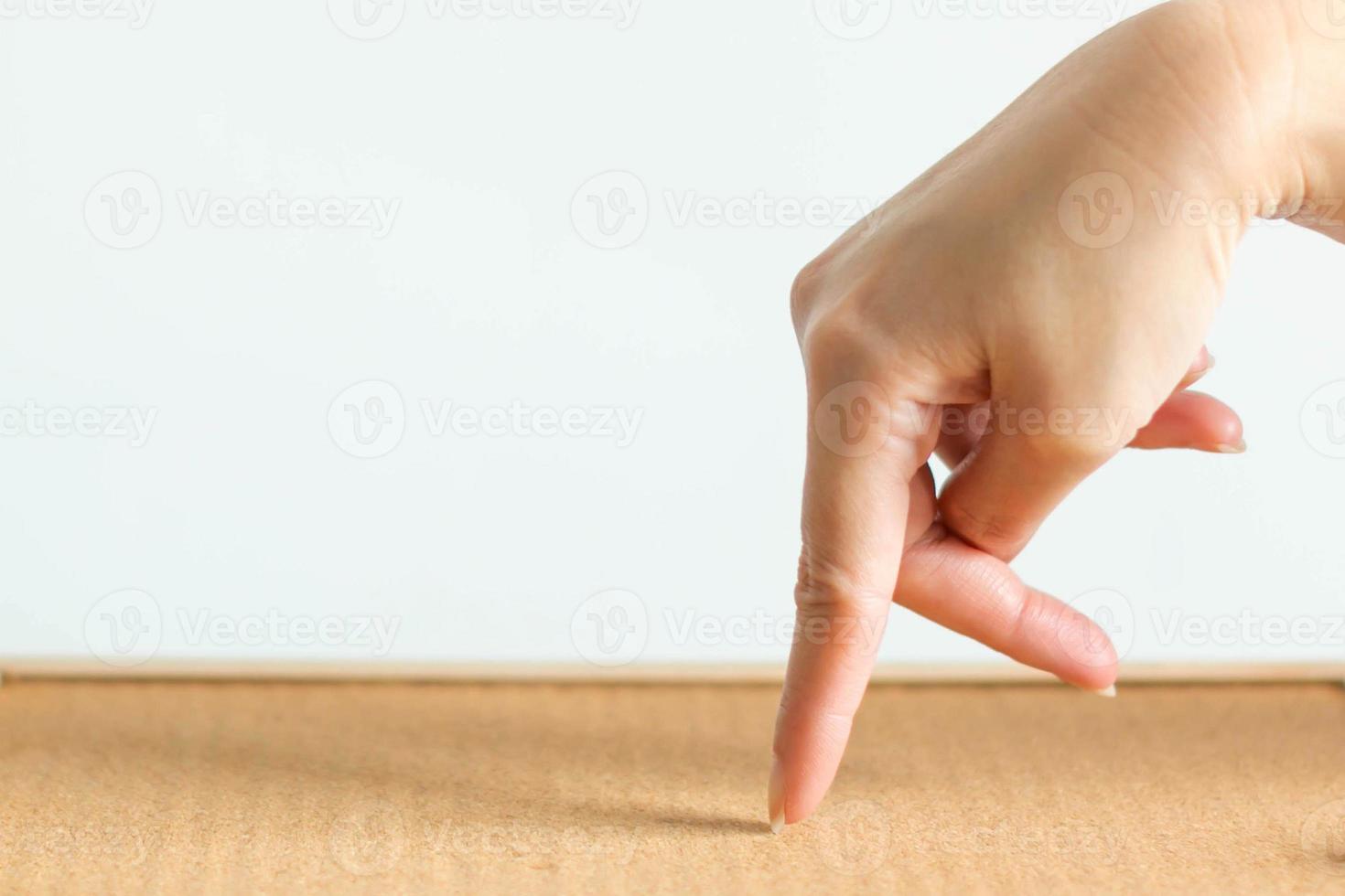 Walking hand symbol on wooden floor. photo