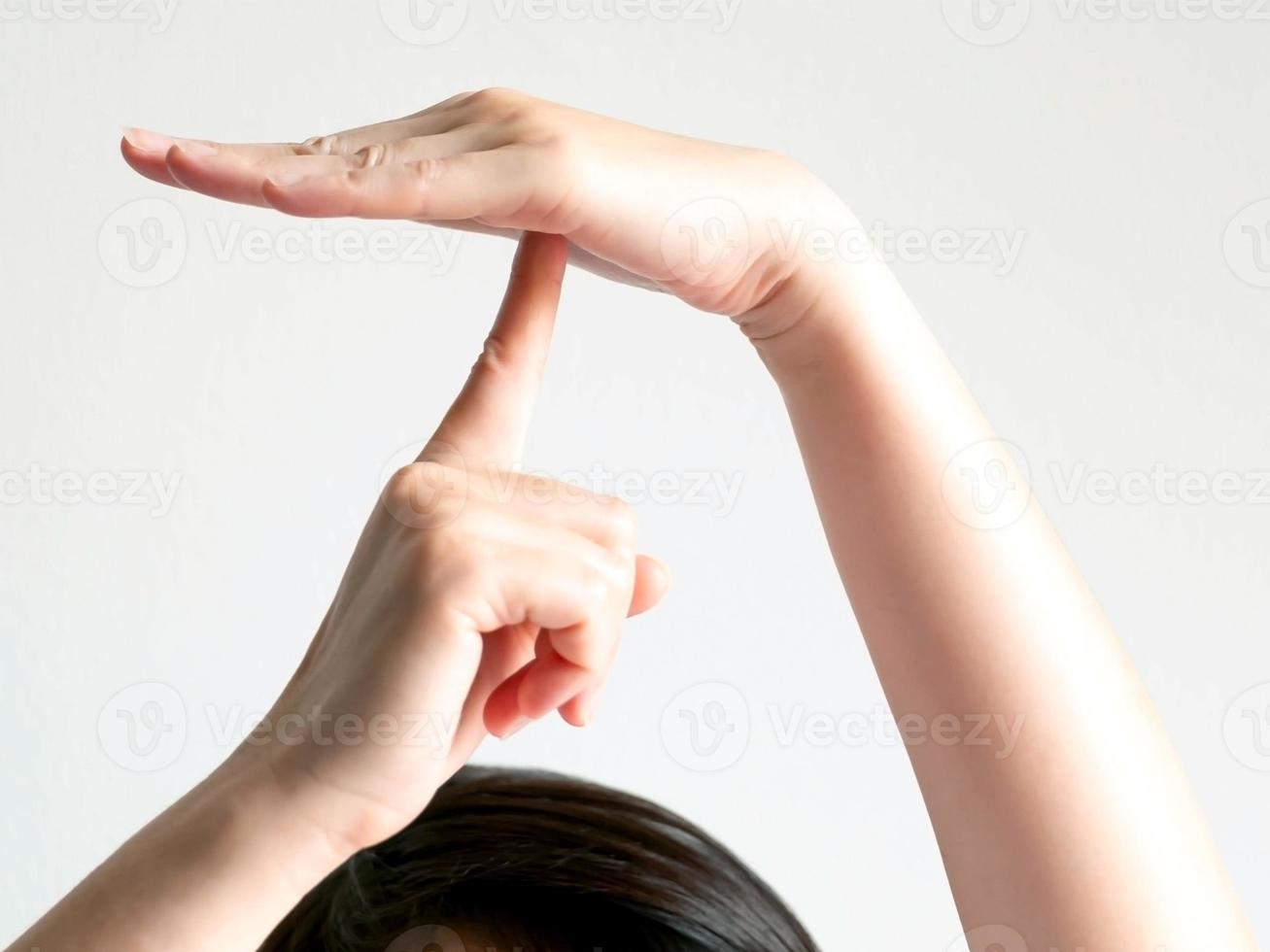 Close-up of hand sign showing umbrella shape on white background. photo