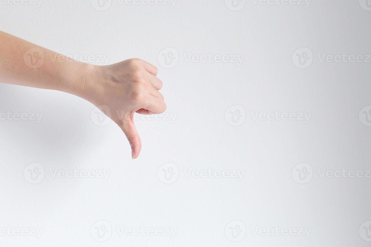 hand showing thumb down gesturing dislike, unlike or disagree. photo
