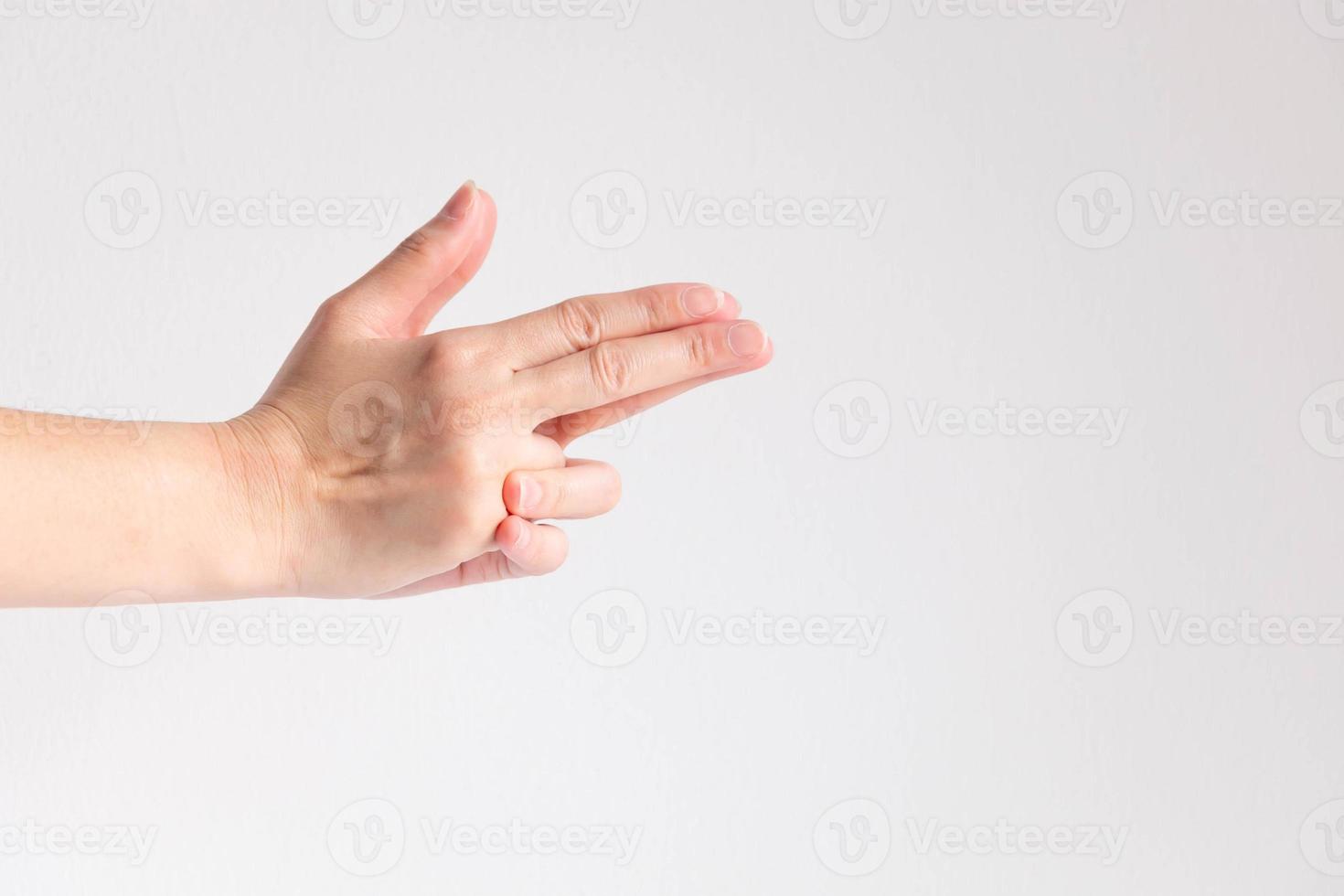 Two hands splice in the shape of the gun on white background. photo