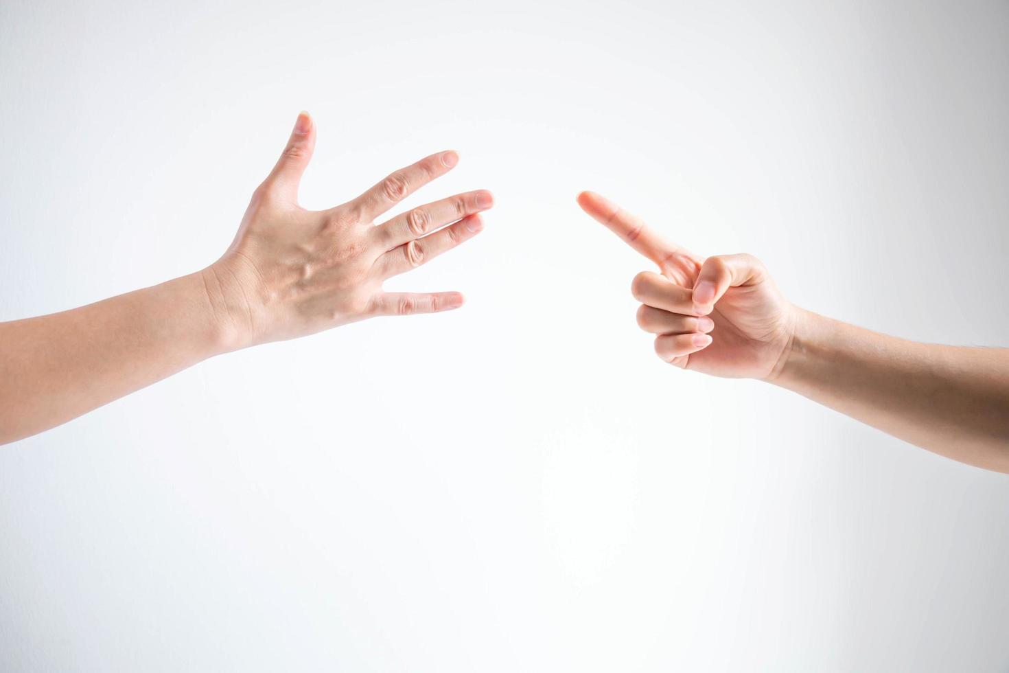 Paper symbol and nail symbol in playing rock paper scissors game on white background. photo