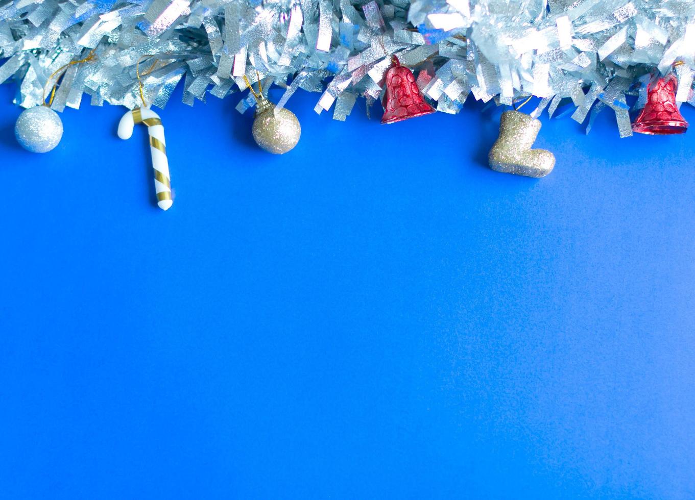 Christmas background. silver and gold balls and trinkets on blue background with copy space. photo