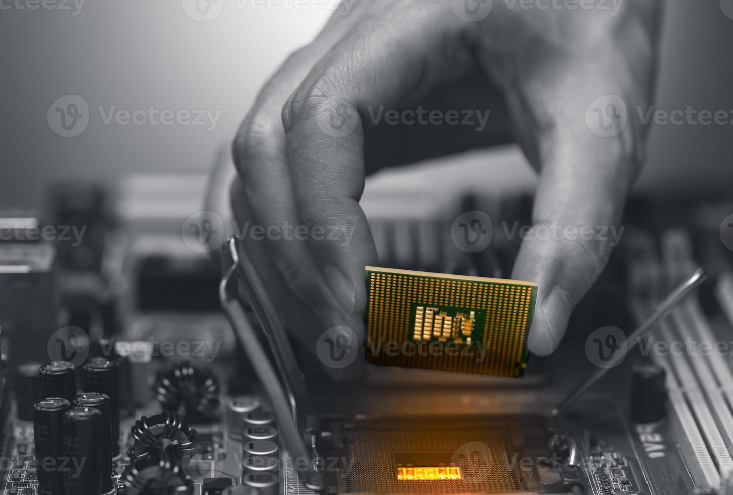 Electronic engineer hand putting computer chip on socket. Chipset on electronic circuit board of PC mother board. CPU chip. Electronic components. Computer hardware. Upgrade computer processor chip. photo