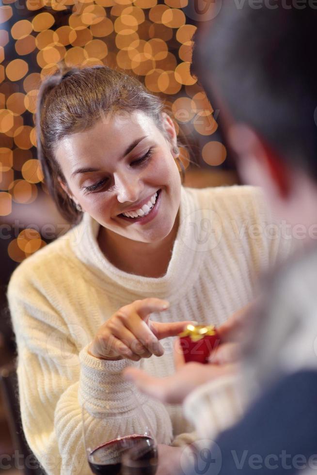 young man gives a gift to girl photo