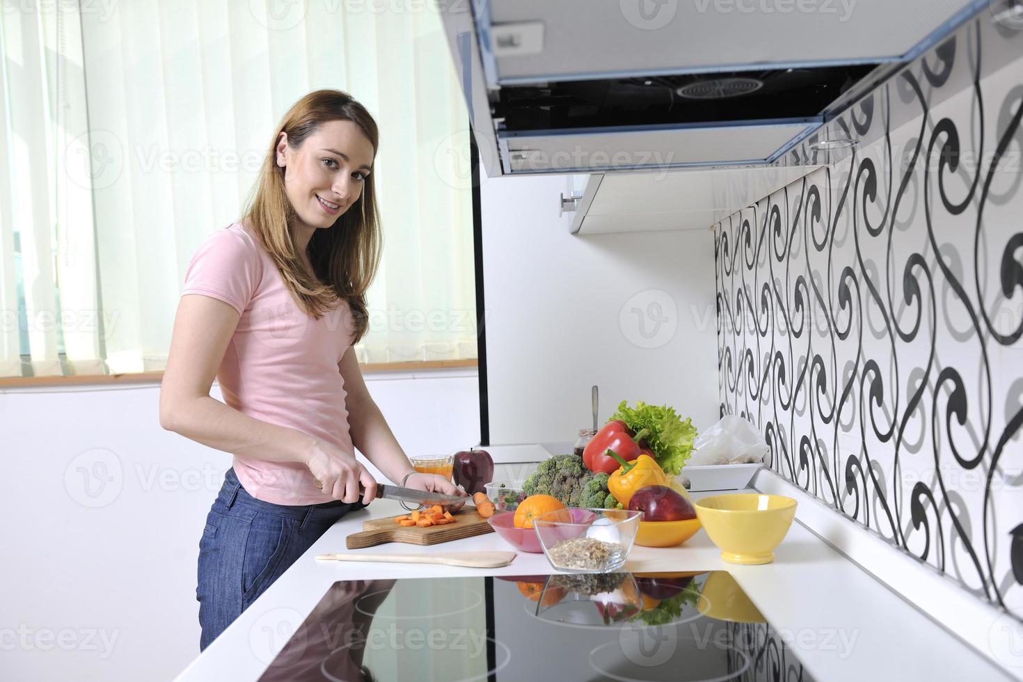 happy young  woman in kitchen photo