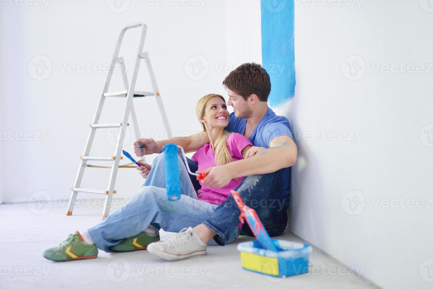 happy young cople relaxing after painting in new home photo