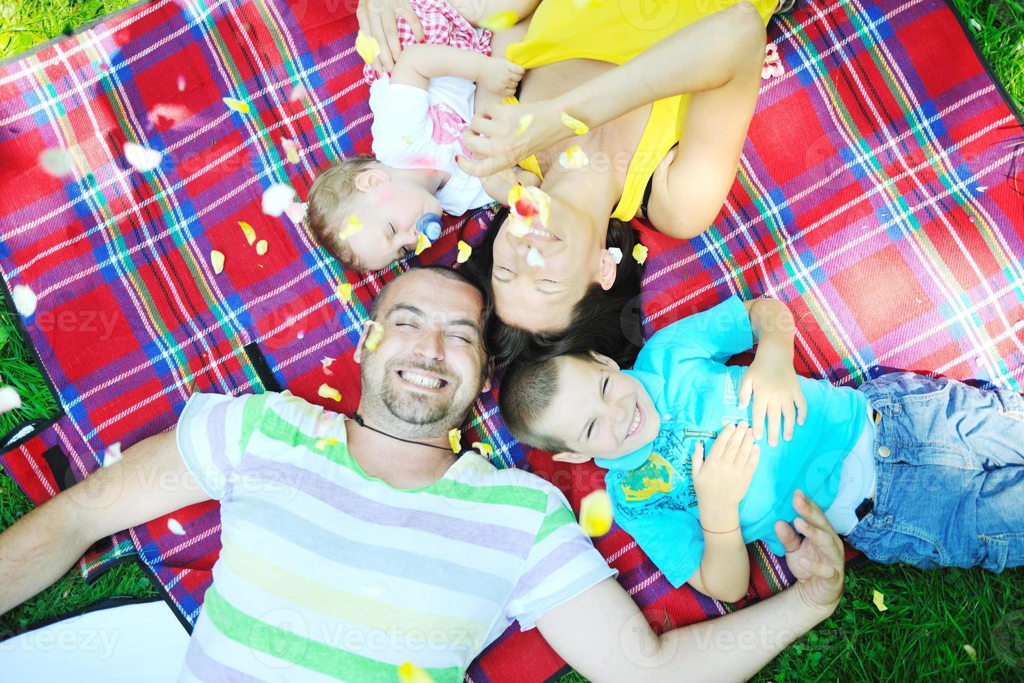 happy young couple with their children have fun at park photo