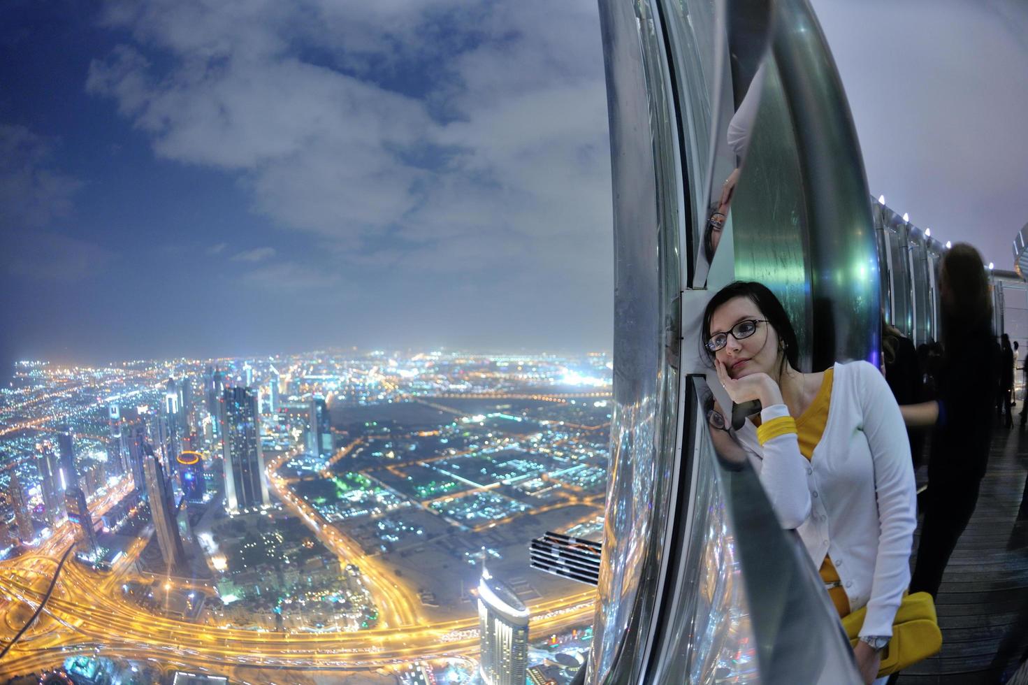 Dubai, 2022 - beautiful woman portrait with big city at night in background photo