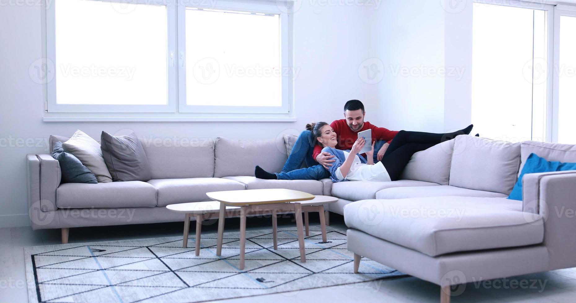 couple relaxing at  home with tablet computers photo
