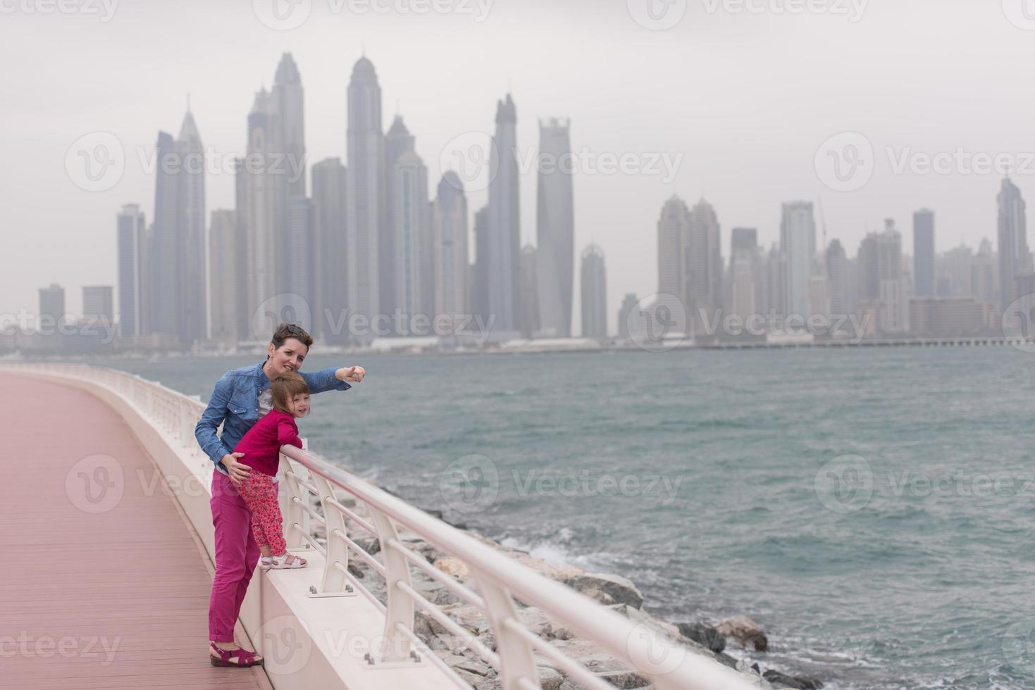 mother and cute little girl on the promenade photo