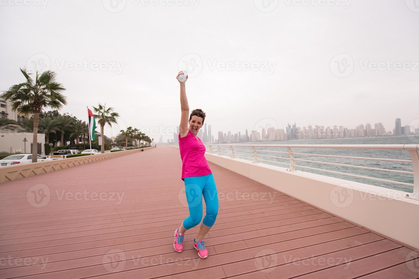 young woman celebrating a successful training run photo