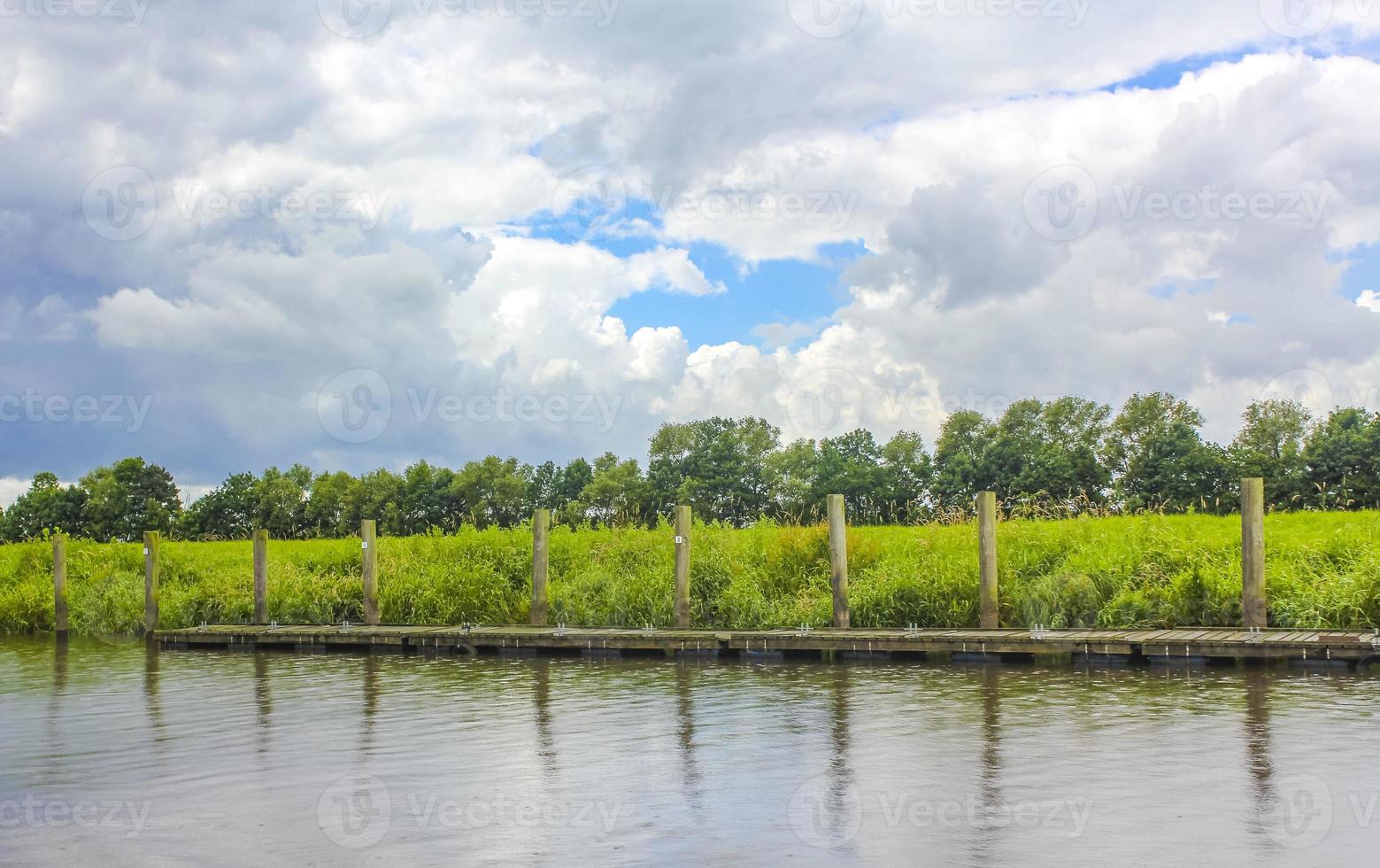 Beautiful natural landscape panorama jetty boat Oste river water Germany. photo