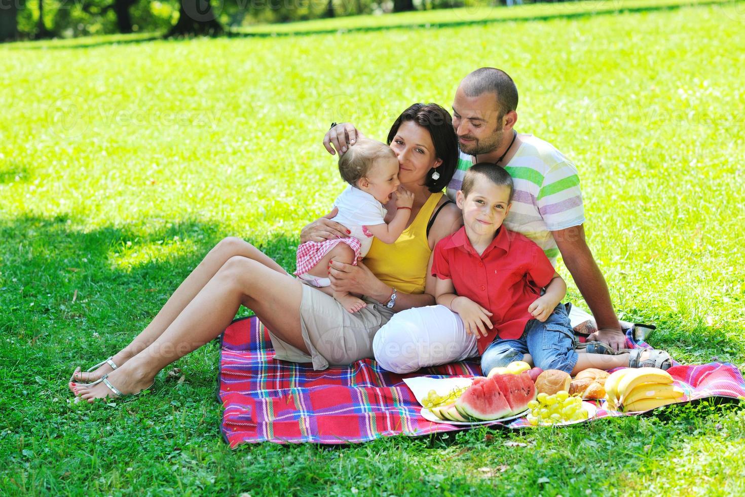 happy young couple with their children have fun at park photo