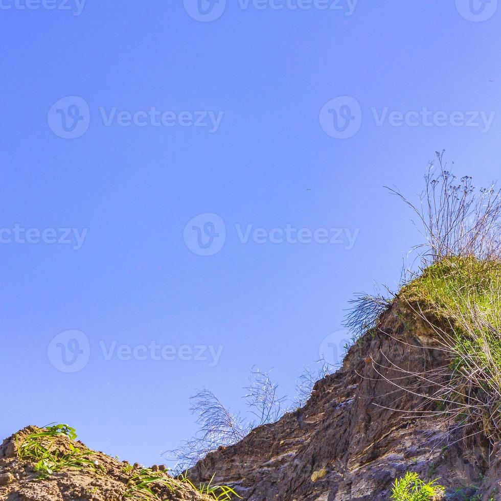 Excavated sand mountains and rubble piles quarry lake dredging pond. photo