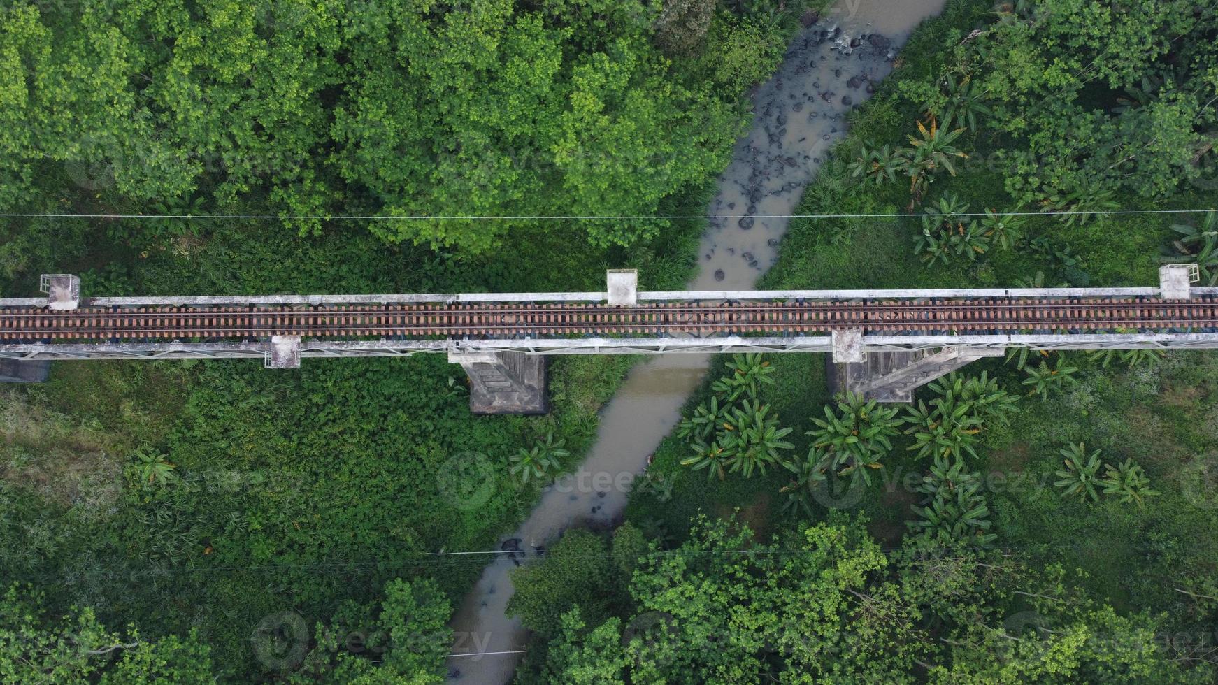 Top view aerial of railways bridge crossing a river photo