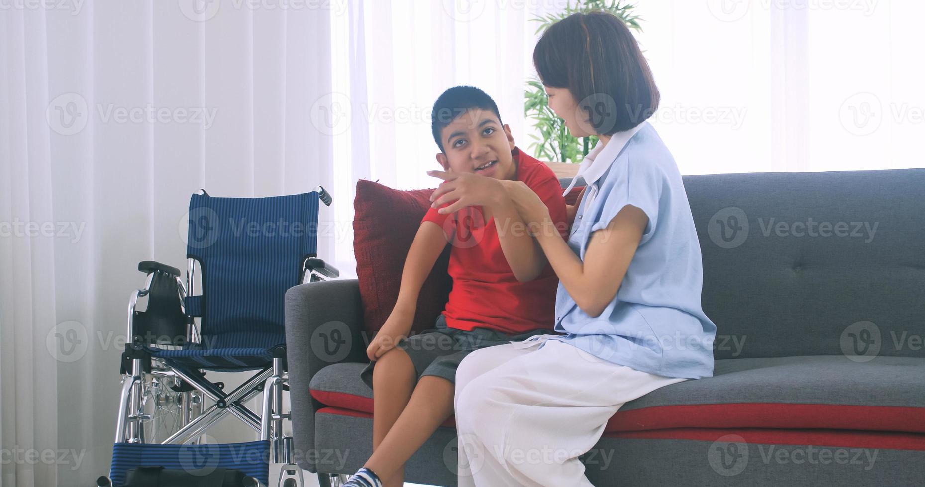 Happy family with mother and disabled son spending time together at home. photo