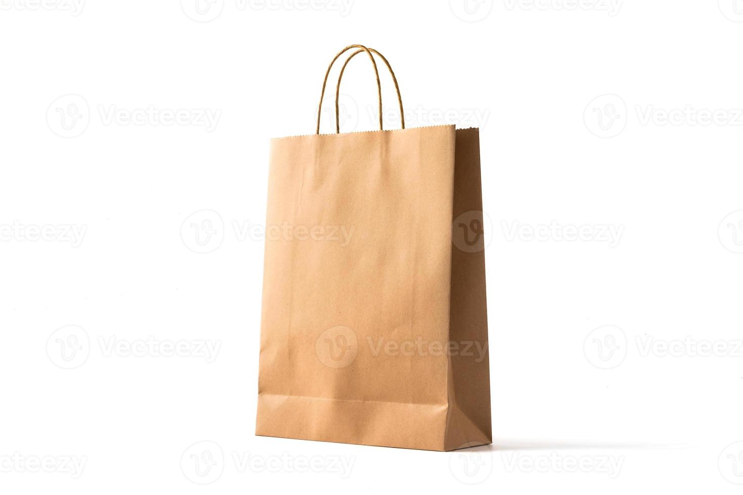Brown paper shopping bag on white background photo