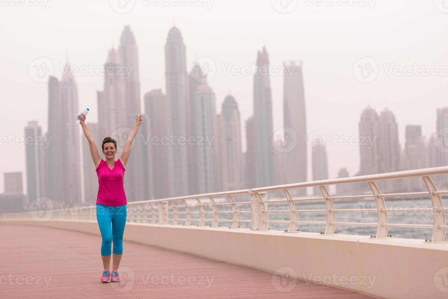 young woman celebrating a successful training run photo