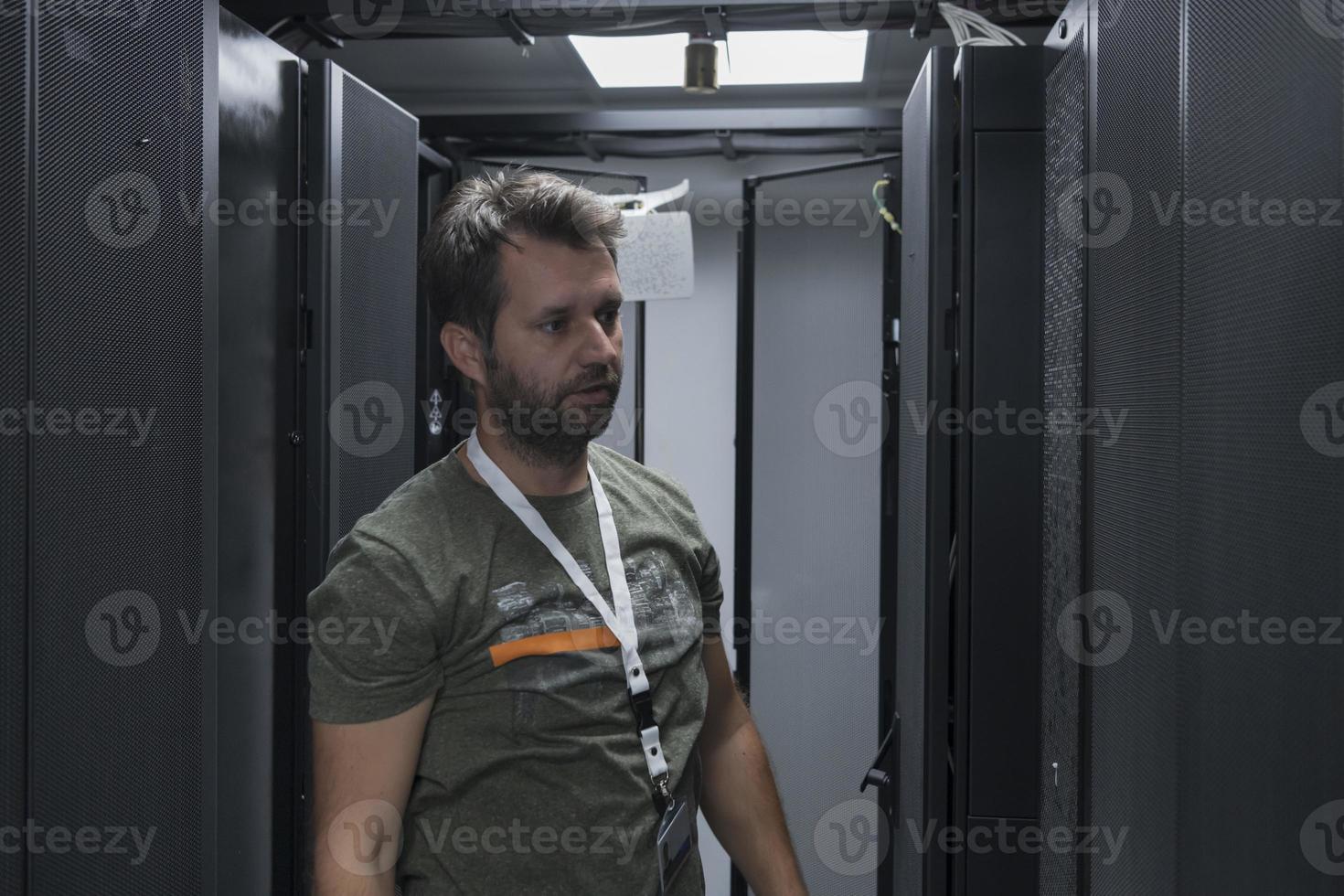 IT engineer working In the server room or data center The technician puts in a rack a new server of corporate business mainframe supercomputer or cryptocurrency mining farm. photo