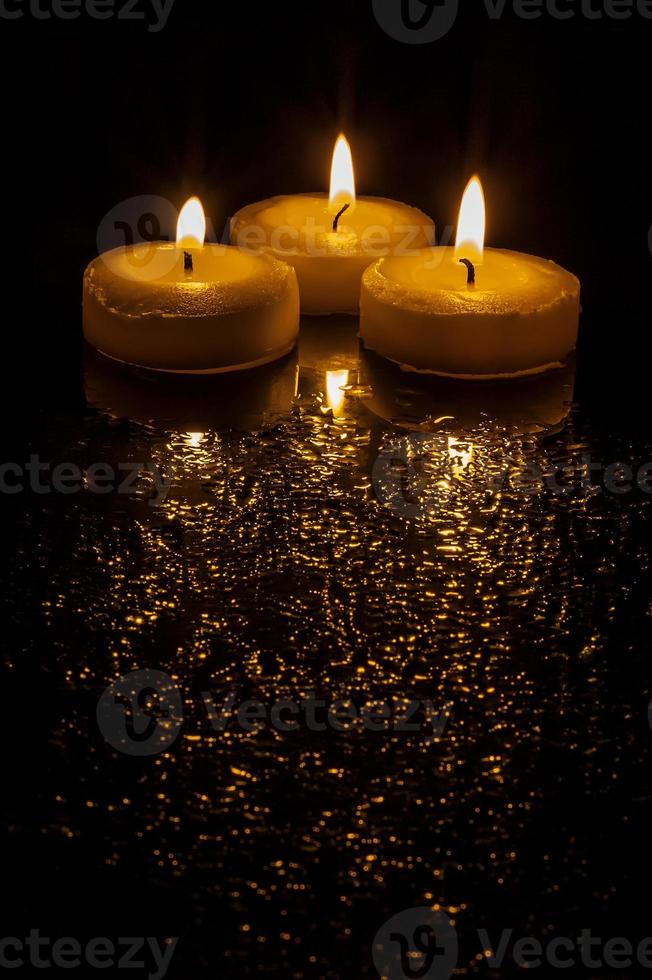 Three burning candles photo