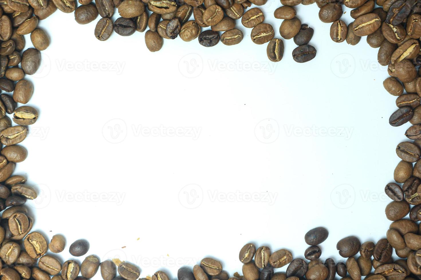 Frame made from roasted coffee beans over white background with room for text or image photo