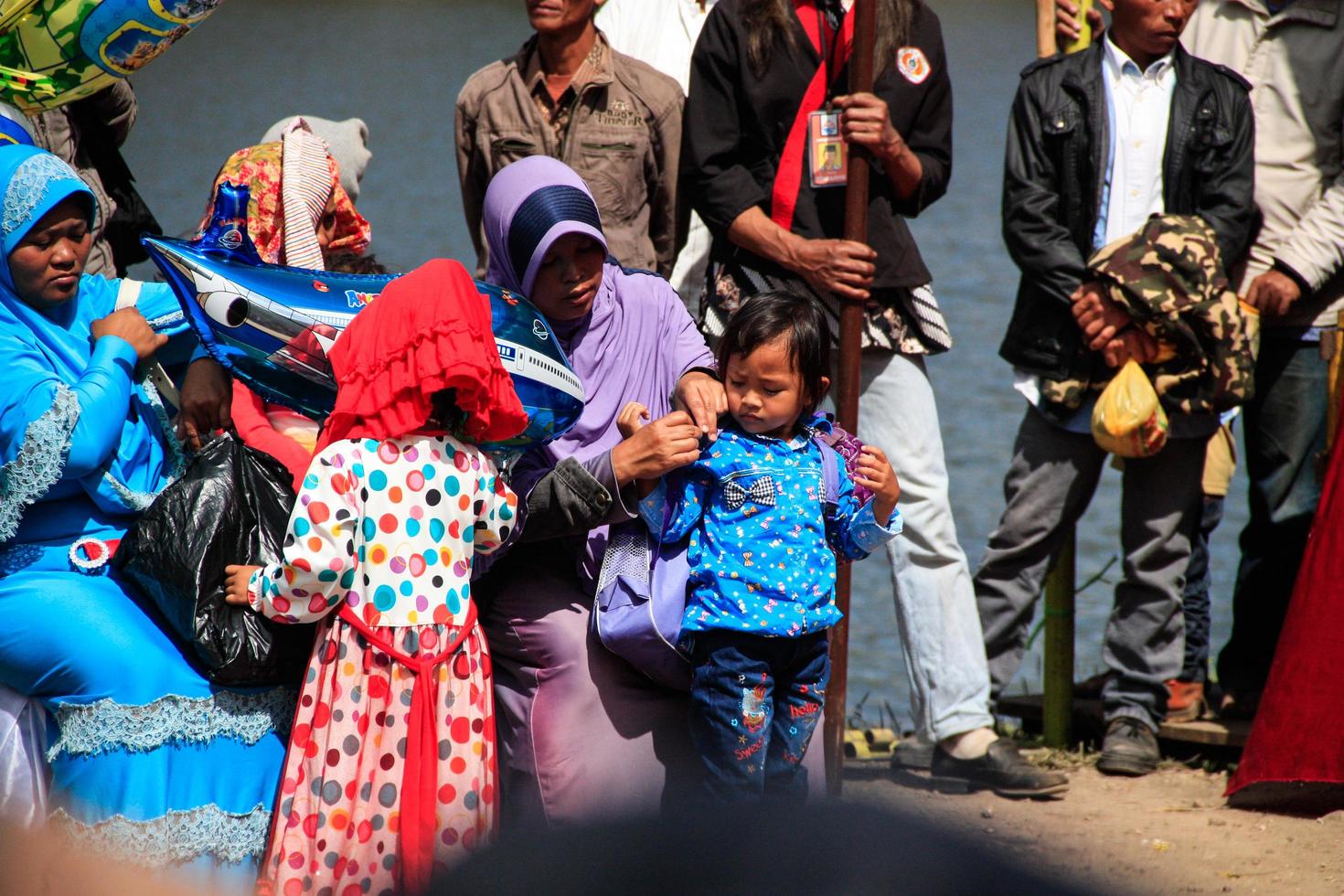 Dieng, Indonesia - August 1, 2015. Dieng Culture Festival, Tourists follow the dreadlocks procession during the Dieng Culture Festival event at Dieng, Banjarnegara district, Central Java photo