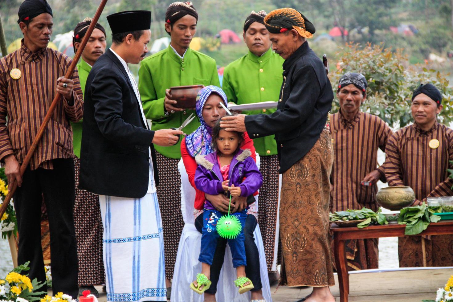 Dieng, Indonesia - August 1, 2015. Dieng Culture Festival, Tourists follow the dreadlocks procession during the Dieng Culture Festival event at Dieng, Banjarnegara district, Central Java photo