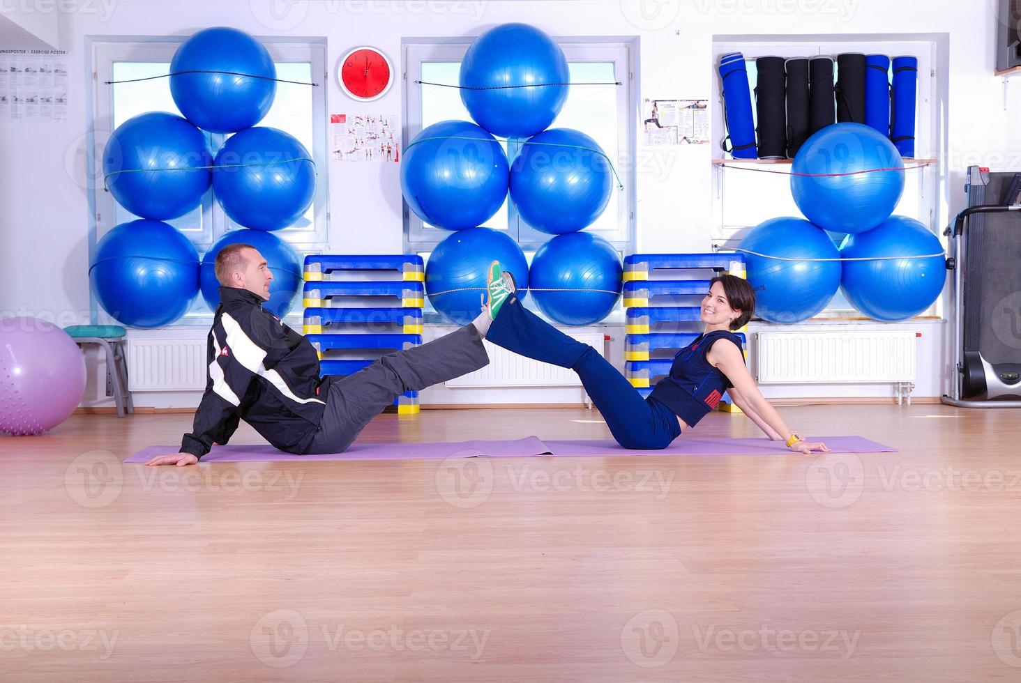 .happy couple at gym working out photo