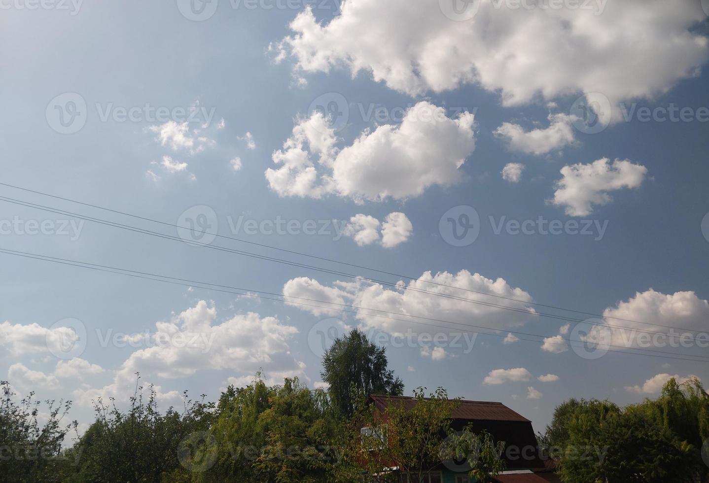 Summer clouds against the blue sky photo