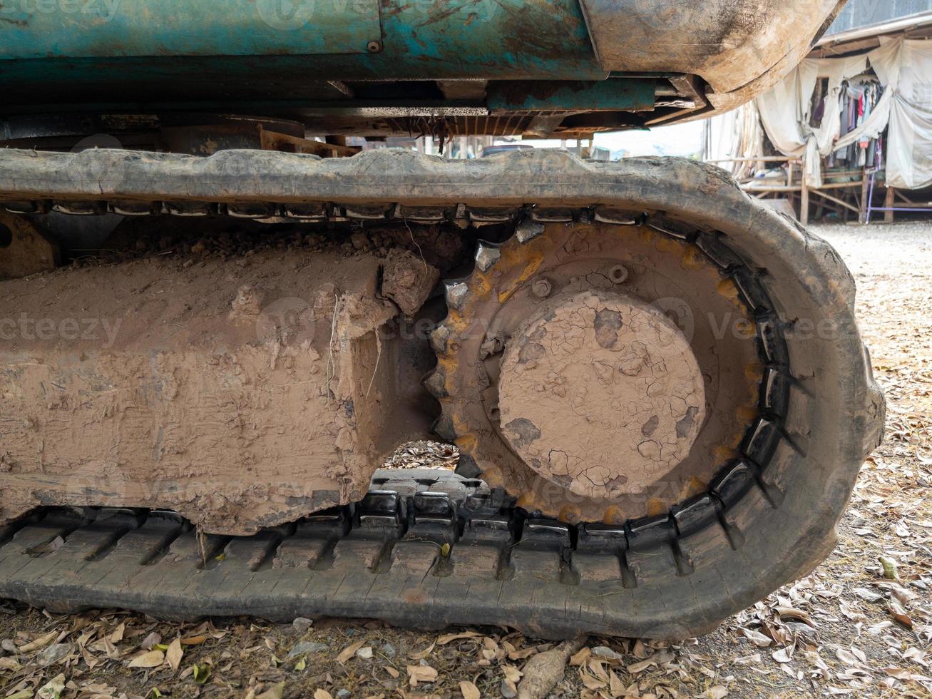 Closeup of the dirty crawler with the dry mud from the paddy field. photo